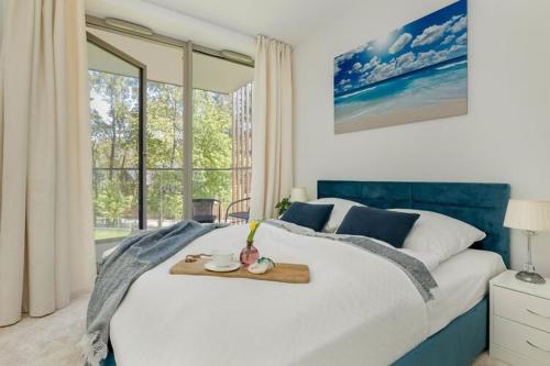 a bedroom with a large bed with a tray on it at Apartment in Pobierowo near Baltic Beach in Pobierowo