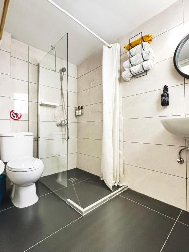 a bathroom with a shower and a toilet and a sink at Home Away One Bedroom Apartment in Nicosia in Nicosia