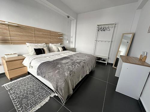 a bedroom with a large bed with a wooden headboard at Home Away One Bedroom Apartment in Nicosia in Nicosia