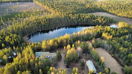 una vista aérea de una casa y un puente sobre un lago en Lapland Old School, en Muonio