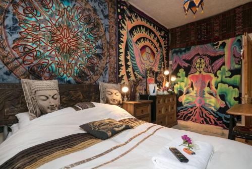 a bedroom with a large bed with a colorful mural at Bradford Digs self contained house in Bradford