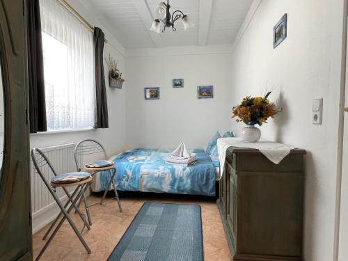 a bedroom with a bed and a table and a chair at Ferienhaus Schmidt in Storkow