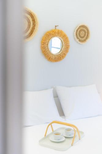 a room with a mirror and two cups on a shelf at Im home in Perea