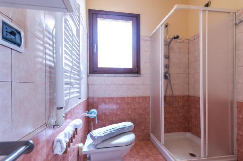 a bathroom with a toilet and a shower at Residence I Mirti in Porto Pozzo