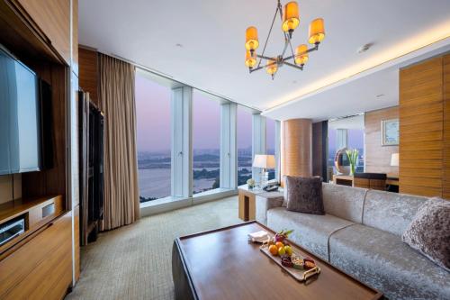 a living room with a couch and a television at InterContinental Nanjing, an IHG Hotel in Nanjing