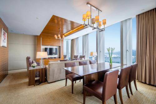 a dining room and living room with a table and chairs at InterContinental Nanjing, an IHG Hotel in Nanjing