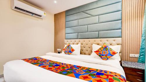a bedroom with a large bed with a colorful blanket at FabHotel Prime D2 in New Delhi