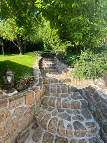 a stone path in a garden with a lamp at Vila Weekend in Rogaška Slatina