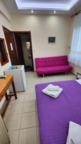 a purple couch in a living room with a purple rug at Prinos Mare in Prinos