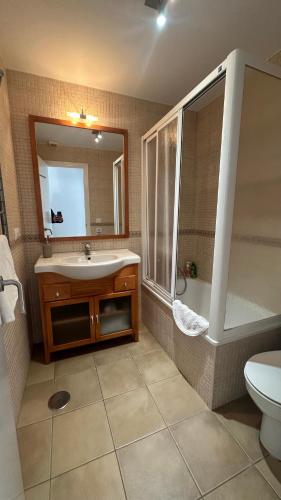 a bathroom with a sink and a shower and a toilet at Mirador Playa in Conil de la Frontera