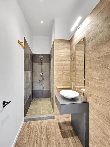 a bathroom with a sink and a shower at POOL AC King Bed Cozy Rooms - Villa Vaiaire in Vaïare