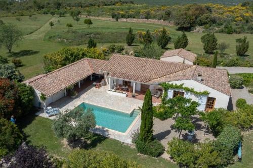 an aerial view of a house with a swimming pool at Le Bariole, luxury villa with heated pool in Cesseras