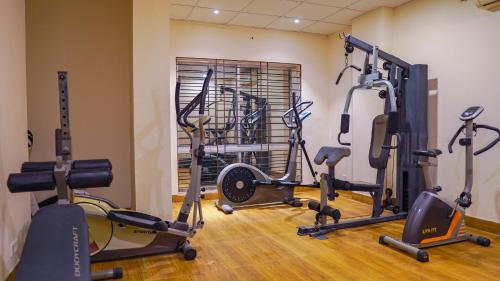 a gym with several exercise equipment in a room at Grand Vistana in Dhaka