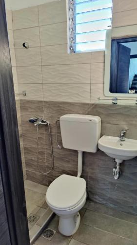 a bathroom with a toilet and a sink at Paschalitsa Rooms in Prinos