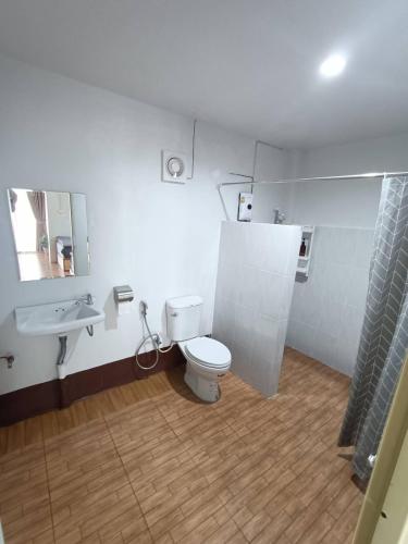 a bathroom with a white toilet and a sink at ม่านฟ้า โฮมสเตย์ MaanFah Homestay in Chiang Rai