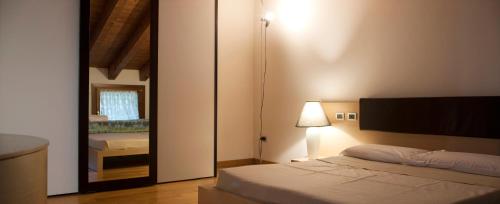 a bedroom with a bed and a large mirror at Albergo Torre in Vicenza