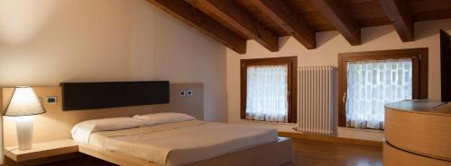a bedroom with a bed and a flat screen tv at Albergo Torre in Vicenza