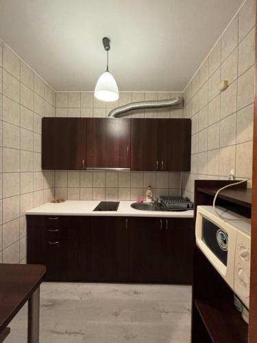 a kitchen with brown cabinets and a white counter top at WILLA ELITA in Krynica Morska