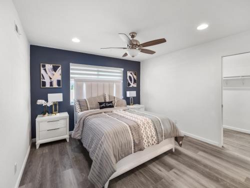 a bedroom with a bed and a ceiling fan at Super Spacious Family Vacation House! in San Diego