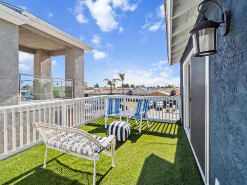 a balcony with two chairs and a table at Super Spacious Family Vacation House! in San Diego