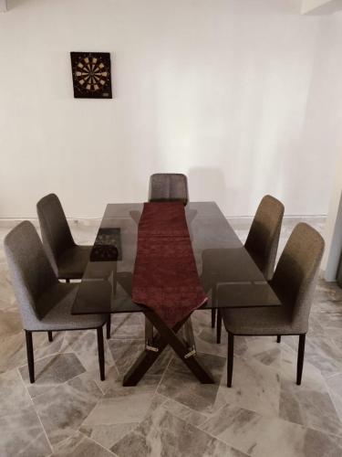 a dining room table and chairs in a room at The CRISNA'S Apartment in Port Dickson