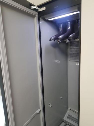 a refrigerator with a glass door and some shoes at Daon 동성로 스타비앤비 레지던스 in Daegu