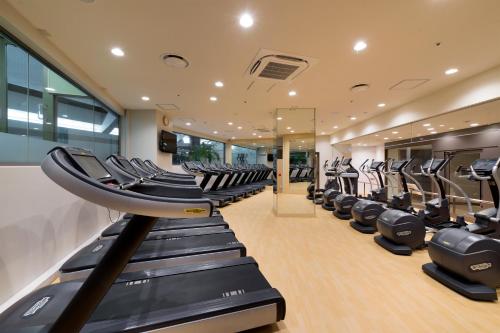 a gym with a row of treadmills at Hilton Tokyo Hotel in Tokyo
