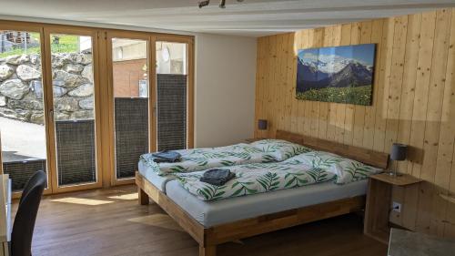 a bedroom with a bed and a view of a mountain at BnB Fellacher in Adelboden