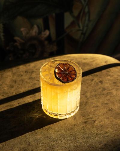 a drink on a table with a grapefruit in it at Hotel Nell - Union Market in Washington