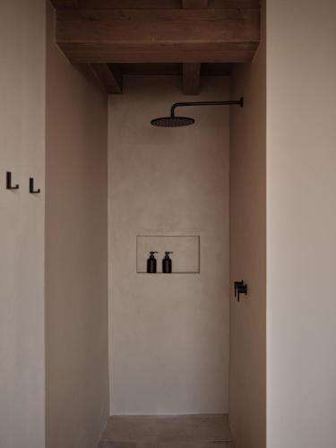 a room with white walls and a wooden ceiling at Borgo SAN SONNEA Lake Garda in Torri del Benaco