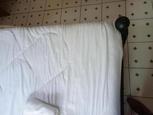 a bed with a white sheet with a heart on it at Melvic inn in Kisumu