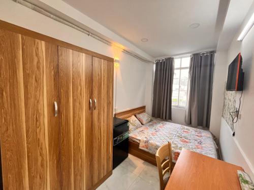 a small bedroom with a bed and a cabinet at Lotus Home-Sunrise Home Extra Best Quality in Ho Chi Minh City