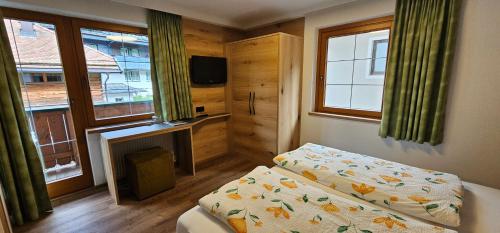 a small bedroom with a bed and a fireplace at Hotel-Garni Pramstraller in Mayrhofen