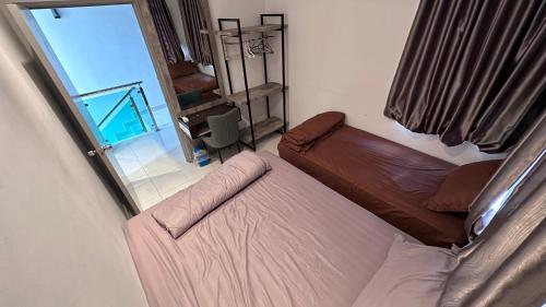 a leather couch in a living room with a window at QuiteSpace in Kluang