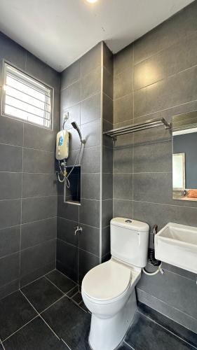 a bathroom with a toilet and a sink at QuiteSpace in Kluang