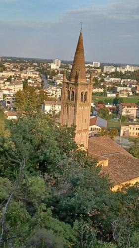 a tall building with a steeple on top of a city at Appartamento casa vacanza Abano Terme Euganean Hills Holiday in Teolo