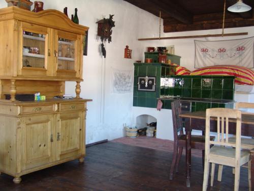a room with a desk and a table and chairs at Penzion Olesnice in Zlatá Olešnice