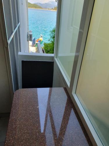 an open window with a view of the water at Apartments Kocak in Blace
