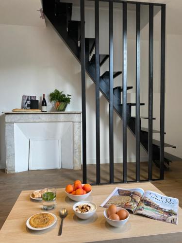 a table with bowls of food on it in a room at Plein Centre Bastia in Bastia