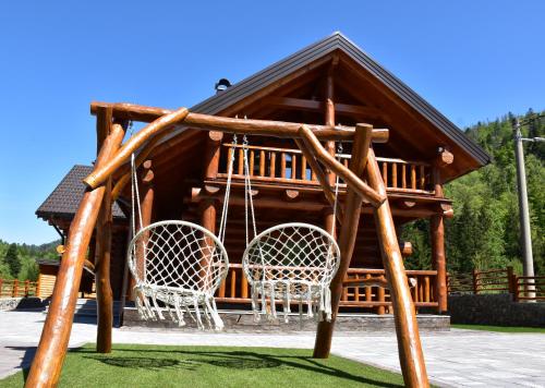 a gazebo with two chairs and a swing at Villa Korina in Fužine