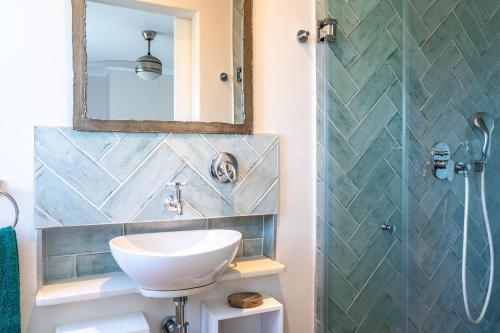 a bathroom with a sink and a shower at Pezula 's Paradise in the Sun - No Loadshedding in Knysna