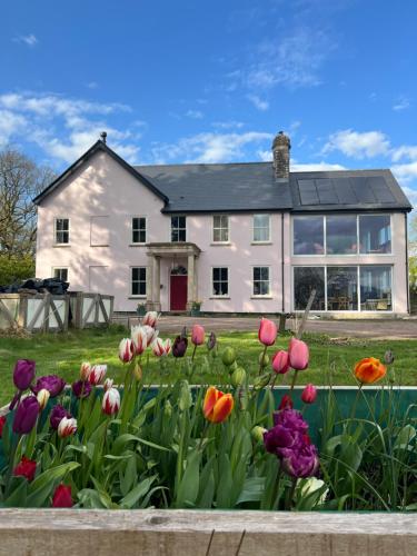 a house with flowers in front of it at The Pink House in Brecon