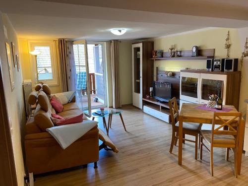 ein Wohnzimmer mit einem Sofa und einem Tisch in der Unterkunft Ferienwohnungen Roiser in Bad Wörishofen