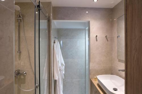 a bathroom with a shower and a sink at La Residence Athens in Athens