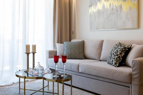a living room with two red wine glasses on two tables at La Residence Athens in Athens