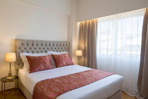 a bedroom with a large bed and a window at La Residence Athens in Athens