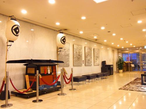 a lobby with chairs and a hammock in a building at Asakusa Central Hotel in Tokyo