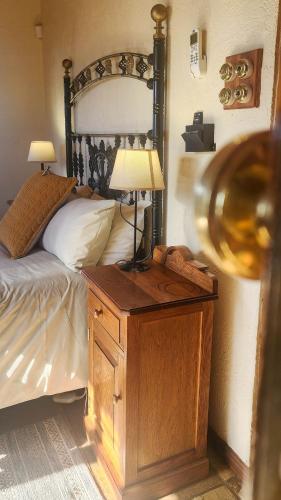 a bedroom with a bed and a table with a lamp at Fossil Hills in McGregor