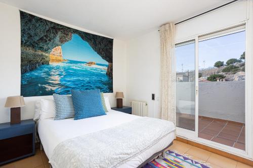 a bedroom with a bed and a large window at House 5 Mins From Montgat Beach in Montgat