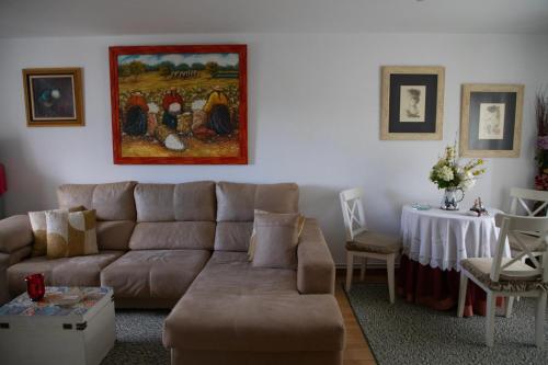 a living room with a couch and a table at Charming house in Teo with balcony and parking included in Rua De Francos